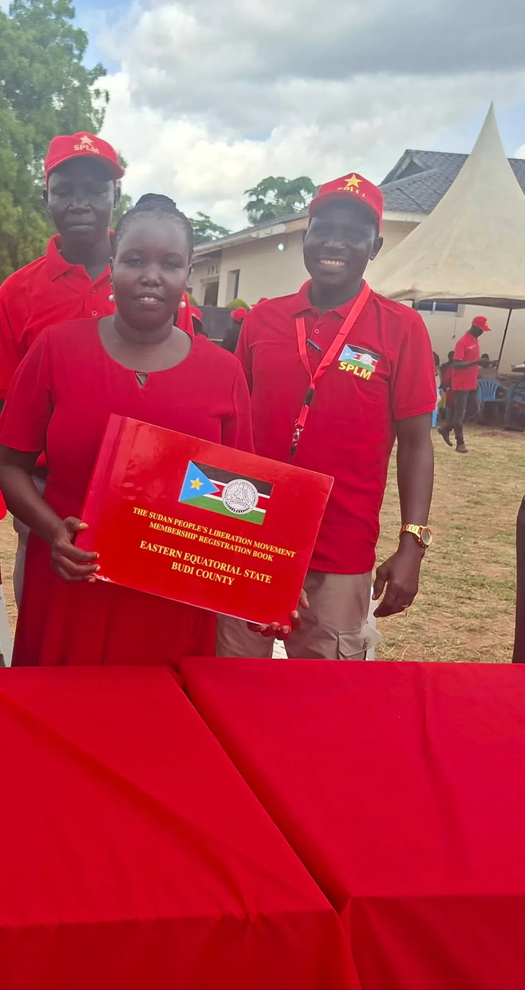 Holding the SPLM membership registration book, Budi County
